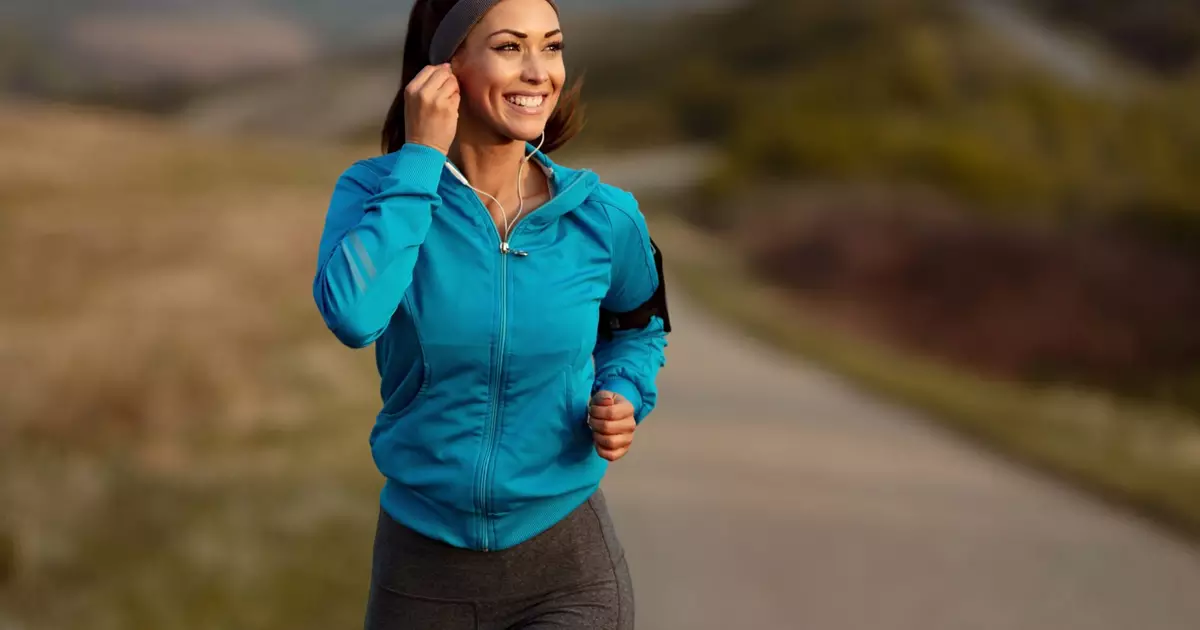 1850128034-happy-athletic-woman-listening-music-earphones-while-running-nature-morning-copy-space-sc.webp
