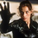 A woman puts her hand u and stares.